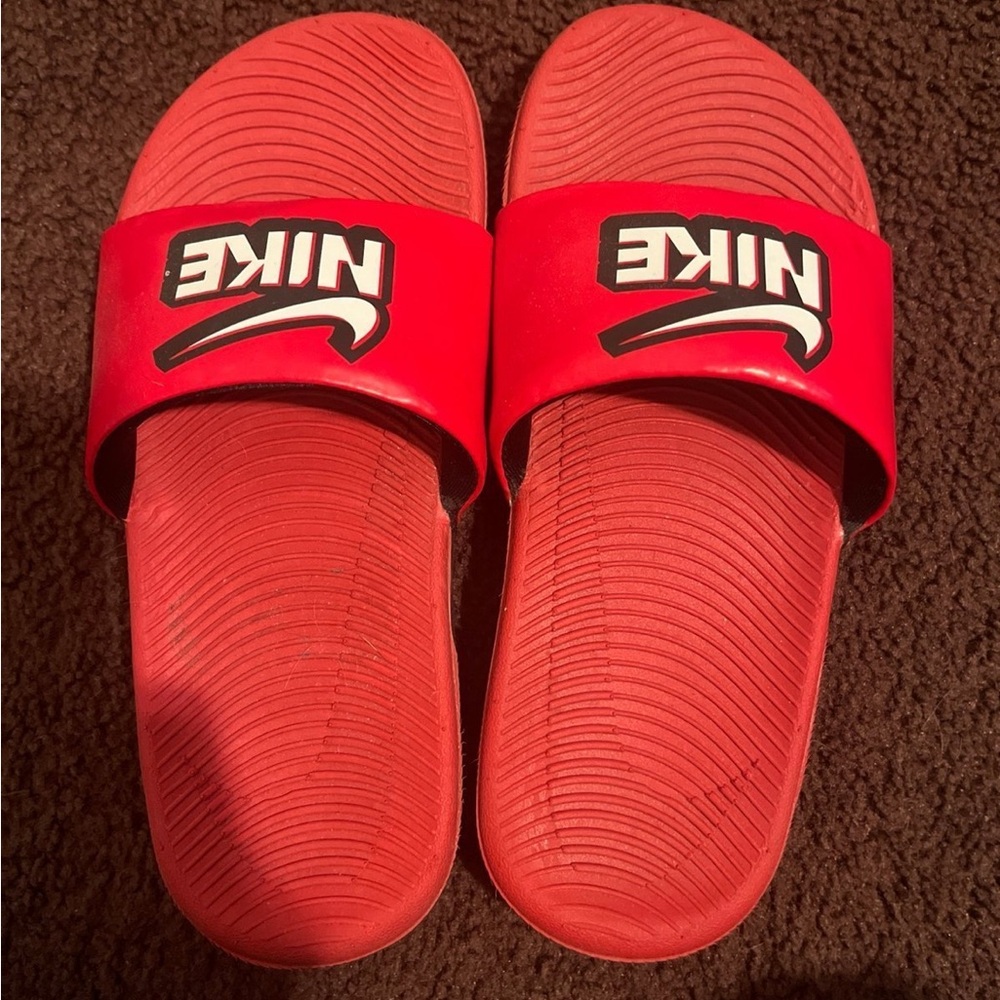 Little boys Nike slides.